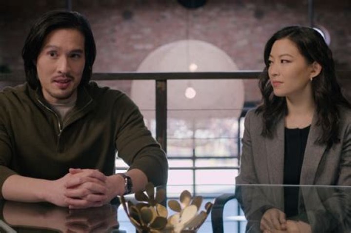 Arden Cho as Ingrid Yun in Netflix series Partner Track episode 1, she is dressed in a pink blazer and sitting at a table Arden Cho as Ingrid Yun in Netflix series Partner Track episode 1, she is dressed in a pink blazer and sitting at a table