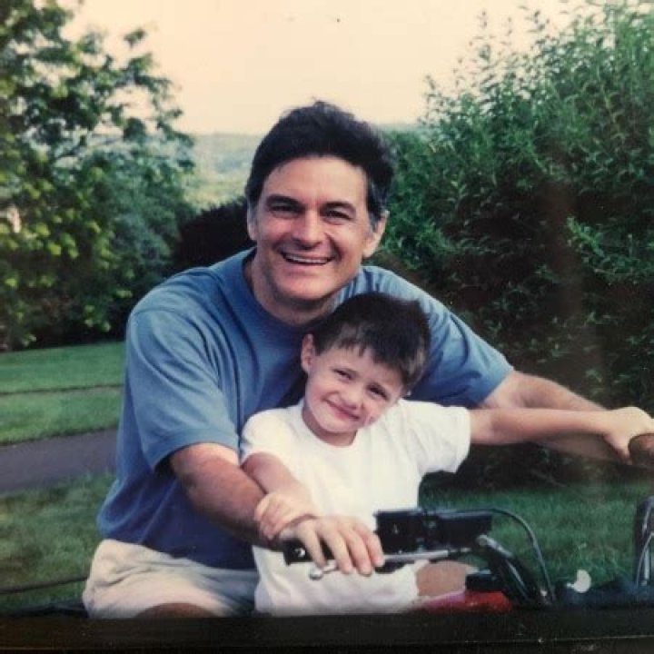 Dr. Oz and his son Oliver Oz riding a bike