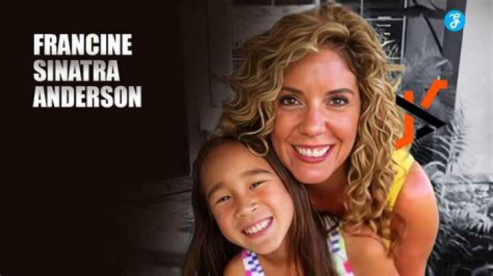 Francine Sinatra Anderson took a picture with a child in her arms