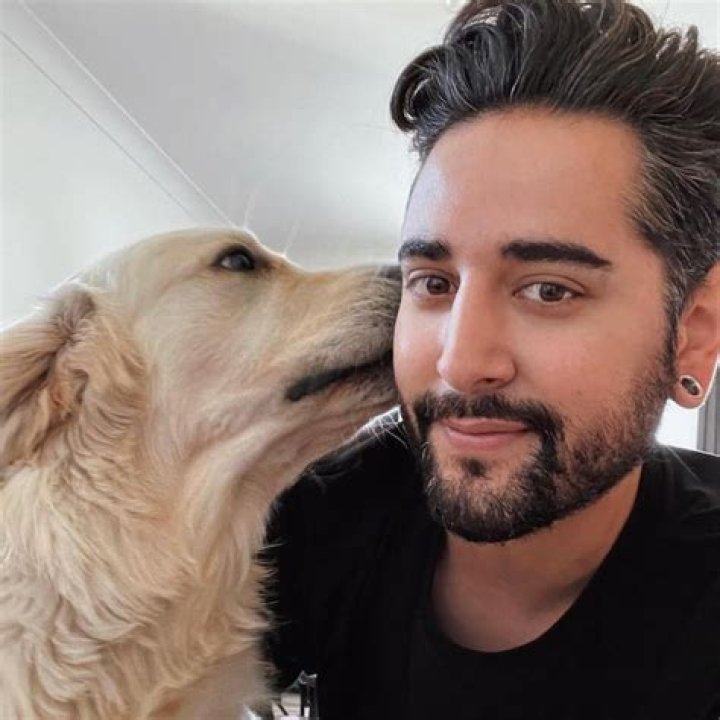 James Welsh being kissed by his 2-year-old dog Bishop on the cheek.