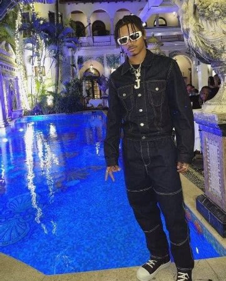 John Nesta Marley chilling beside a swimming pool in a luxurious resort 