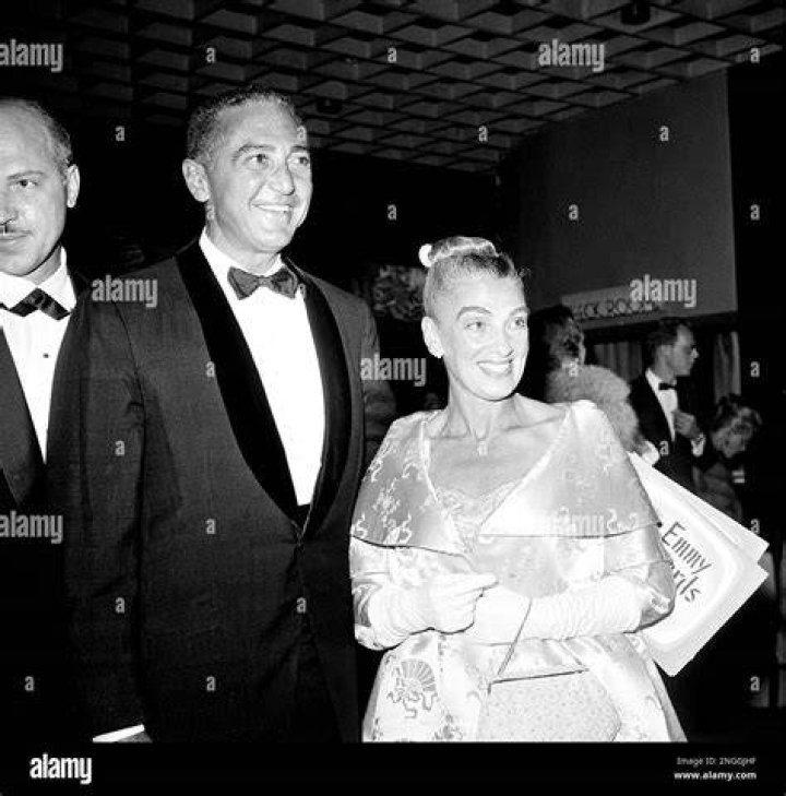 Leonard and his wife posing together during an event.