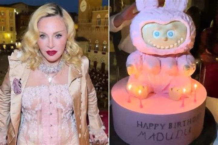 Madonna is cutting the cake as Stelle Ciccone looks on.