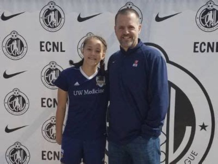 Mario Banchero is on his track and suit whereas, Mia Banchero is wearing her football team jersey.