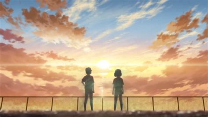 Mutsuko Adachi in a light pink shirt with her daughter in a dark pink t-shirt and her husband in a dark blue shirt.