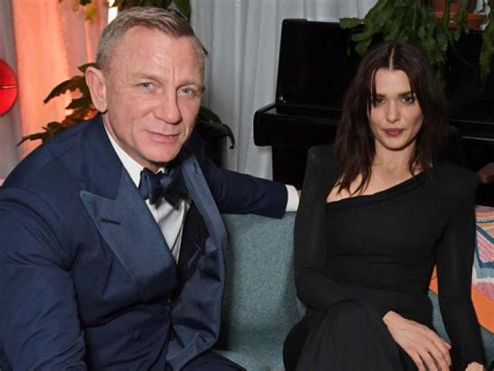Rachel Weisz is hugging Daniel Craig from behind in this pic.