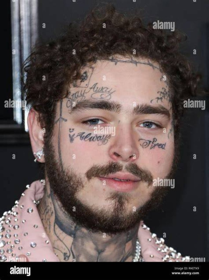 Rapper Post Malone wearing a Charbel Zoe dress arrives at the 2019 American Music Awards held at Microsoft Theatre L.A. Live on November 24, 2019 in Los Angeles, California, United States.