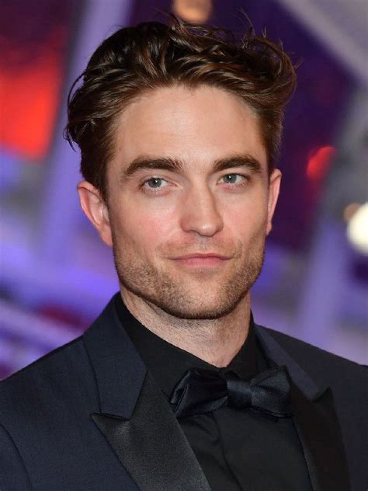 Robert Pattinson poses in front of his dedicated beach locker room during the 43rd Deauville American Film Festival