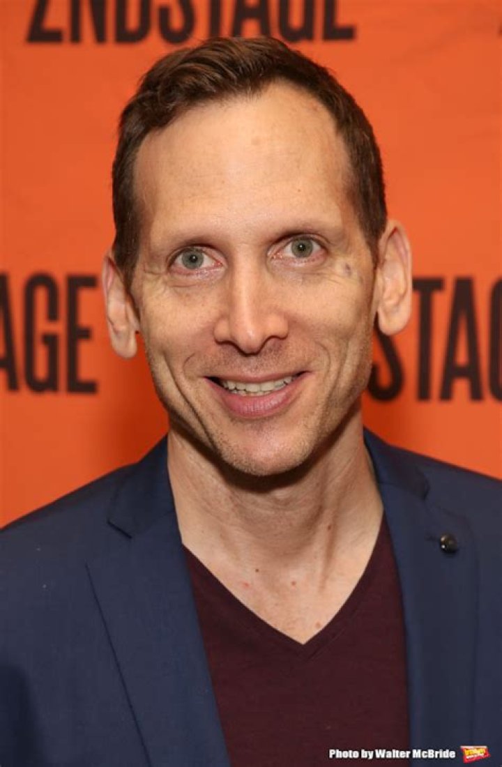 Stephen Kunken's father in a black shirt and pants with Naomi in a grey dress.