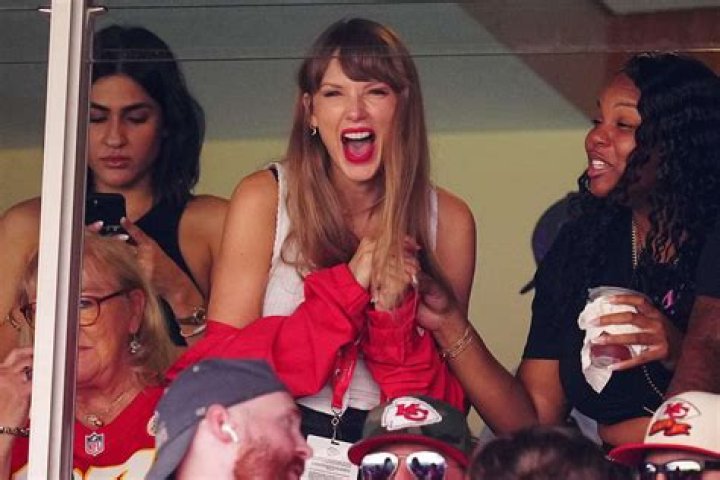 Taylor Swift looking happy holding a cat in Me! Music video